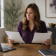 Woman at a desk comparing two affiliate program documents beside a laptop